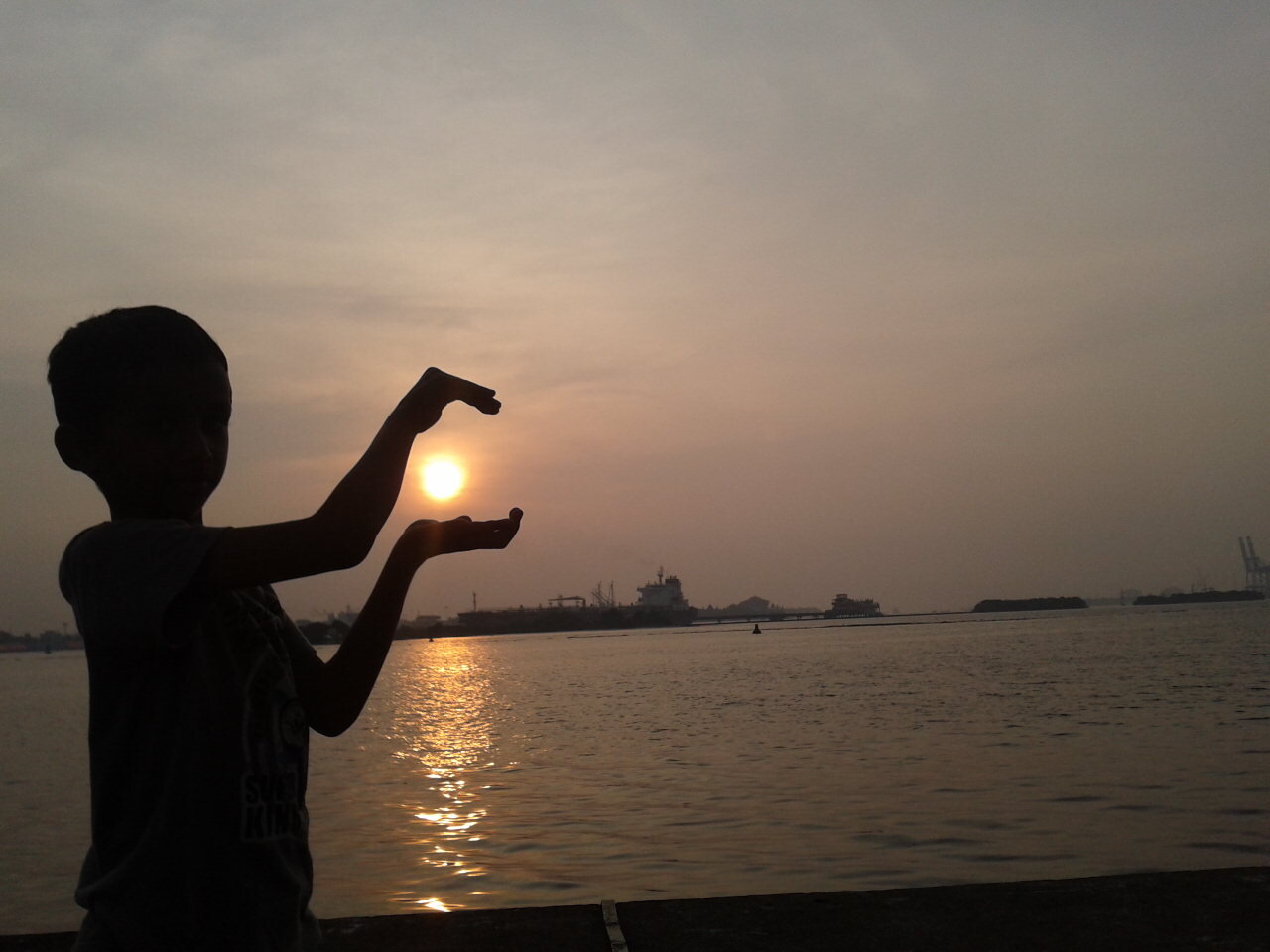 me at the beach - holding the sun